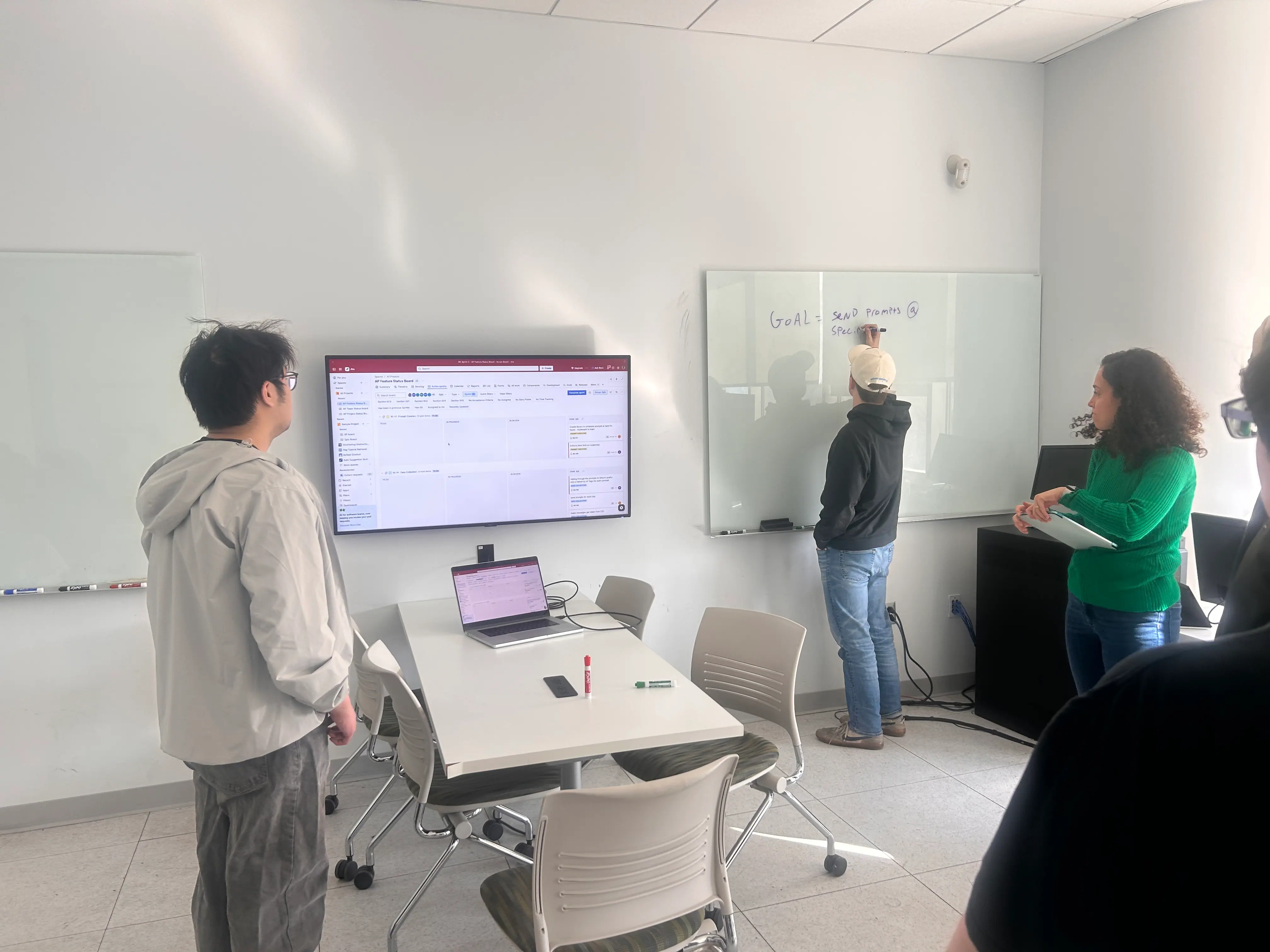 Temple capstone students working together around a table during an event storming exercise